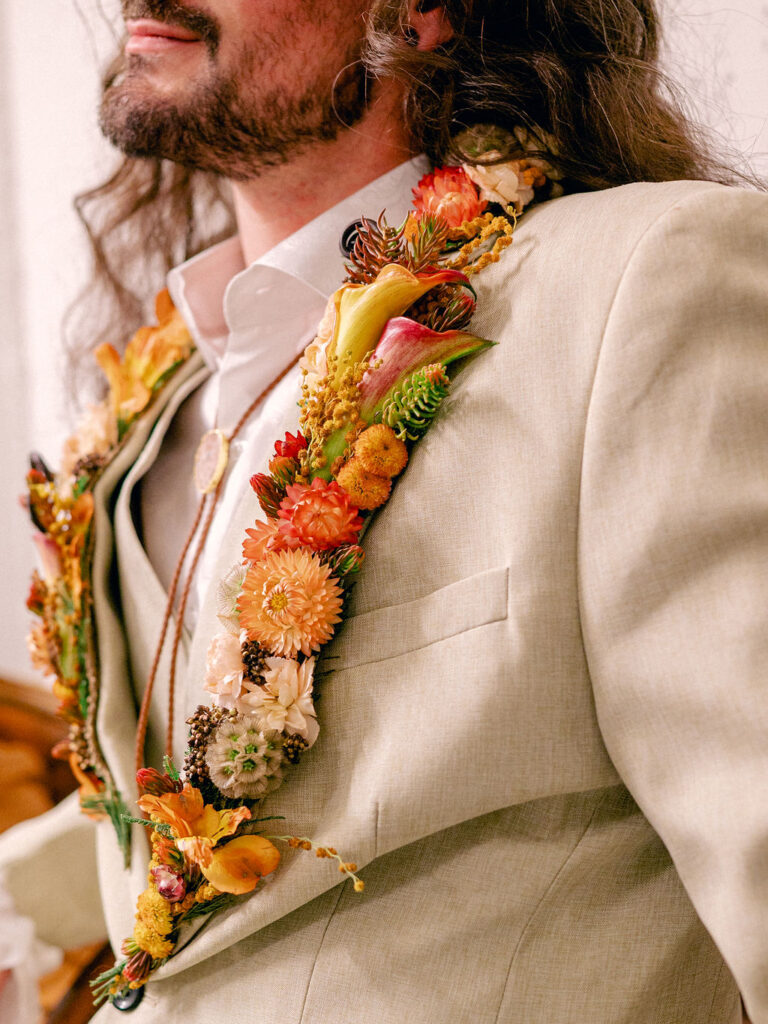 Wearable florals on a groom's suit at a western inspired LGBTQ wedding in Colorado.