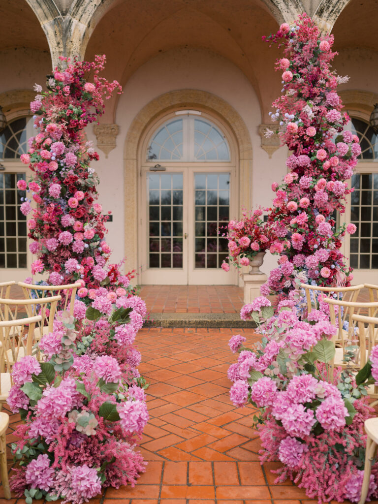 Wedding ceremony at the Philbrook Museum with enormous pink floral installation.
