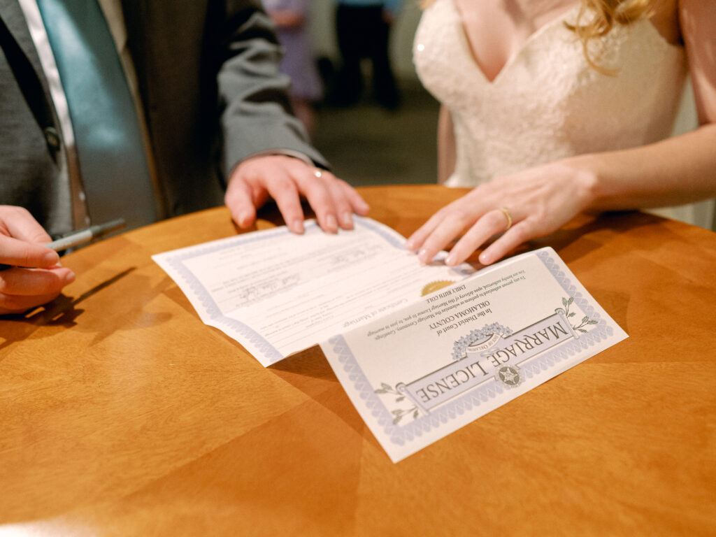 Bride and groom sign marriage license.