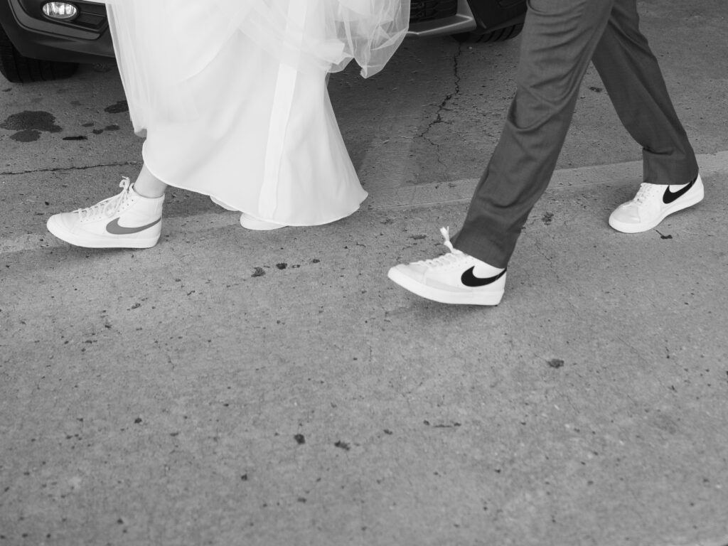 Bride and groom exit ceremony in matching Nike Blazers.