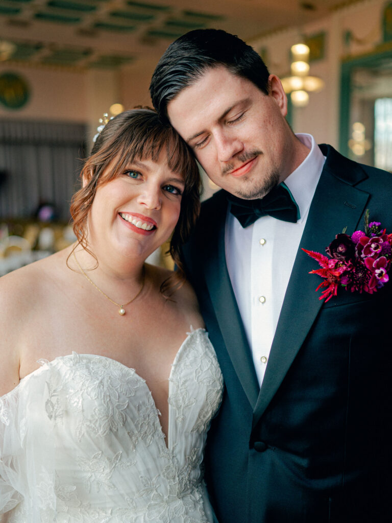 A portrait of a bride and groom leaning their heads together at their Oklahoma City wedding.