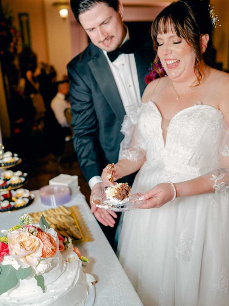 A bride and groom cut their wedding cake.